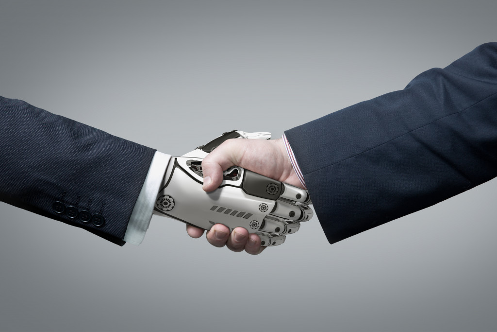 robot hand shaking human hand concept of artificial intelligence